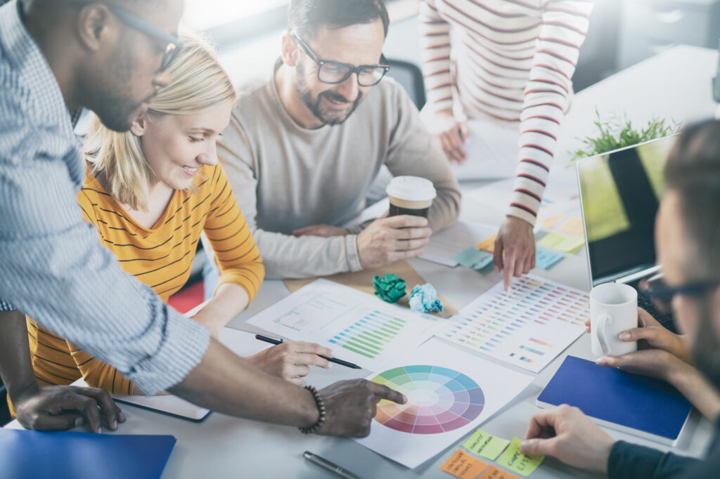 Group of people discussing and pointing to a color wheel