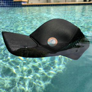 Baseball cap floating in pool