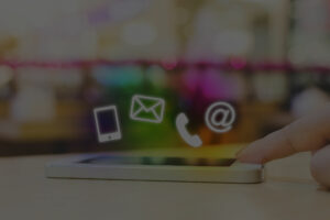Finger touching phone with icons hovering above